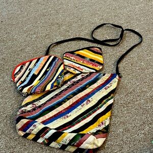 Arty shoulder bag with matching medium and small zipper pouches.